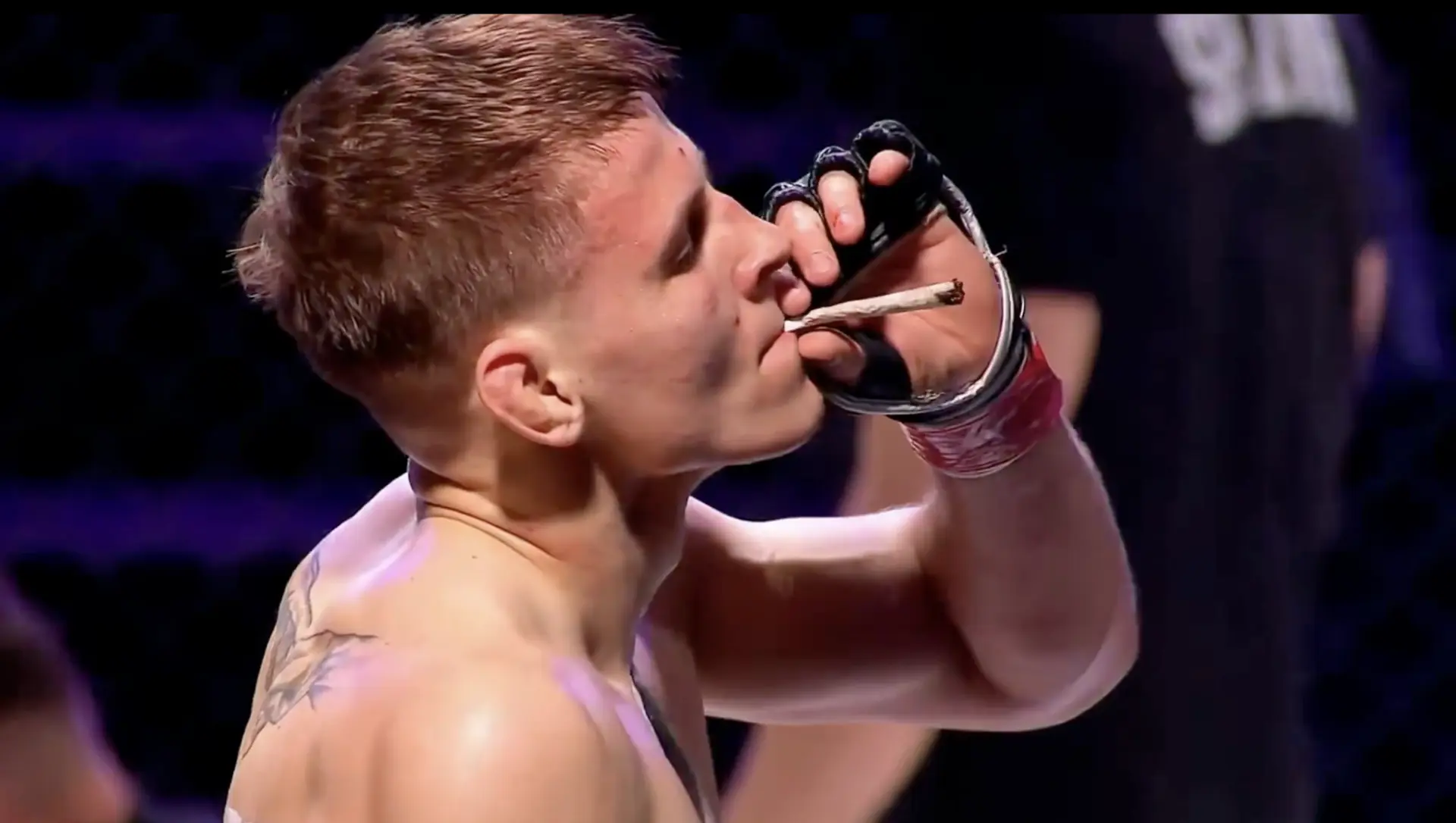 MMA fighter lighting a joint in the cage after his victory